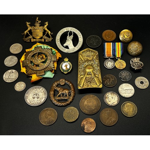 402 - A collection of WWI regimental cap badges mainly commonwealth, together with a small number of coins