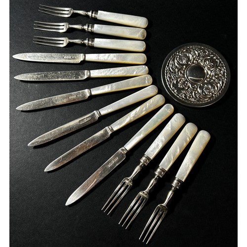 205A - A Harrods mother of pearl set of silver fruit knives and forks and a small silver pocket mirror.