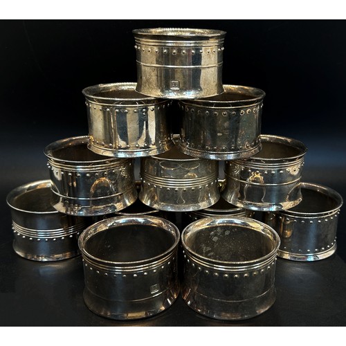 233 - A matching set of ten silver napkin rings, a silver salt and pepper pot together with ten silver pla... 