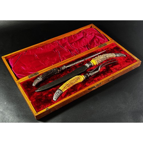 263A - A substantial 19th century carving set with stag horn handles in an oak box  together with a wrought... 