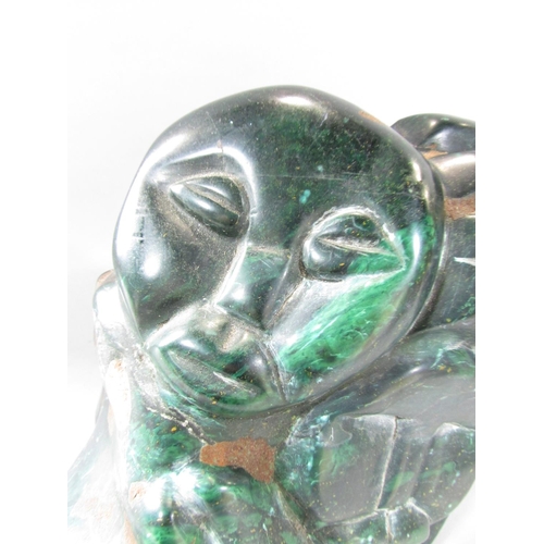 465 - A Zimbabwe Shona Stone Carving of two people embracing, 22cm x 24cm.