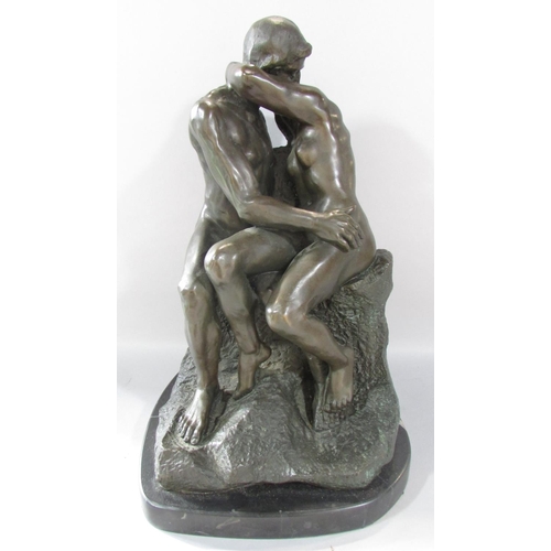 466 - A bronze sculpture of “The Kiss” after Rodin, raised on a marble plinth, 40cm high x 25cm wide.