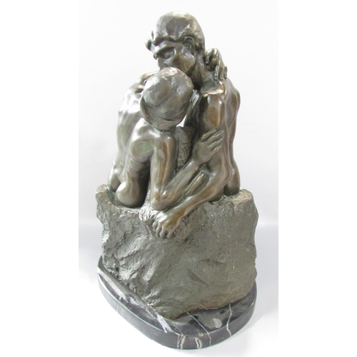 466 - A bronze sculpture of “The Kiss” after Rodin, raised on a marble plinth, 40cm high x 25cm wide.