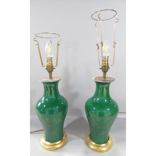 473 - A pair of green porcelain vase lamps, possibly Chinese.