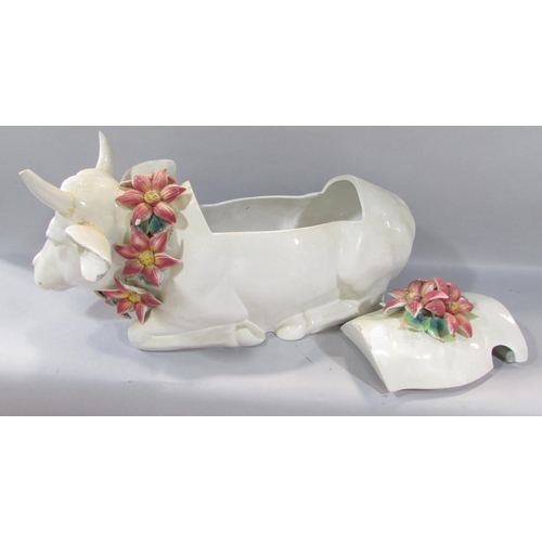 476 - A large novelty ceramic storage cow wearing a garland of flowers, together with a pair of classicall... 