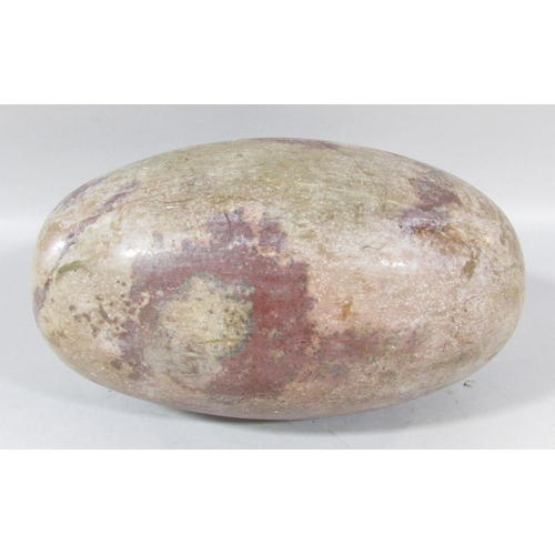 486 - An Indian natural stone Shiva Lingam 25cm wide.