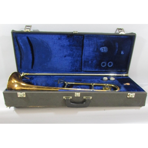 A Vintage Boosey & Hawkes brass trombone, with two mouth pieces in it’s original case.