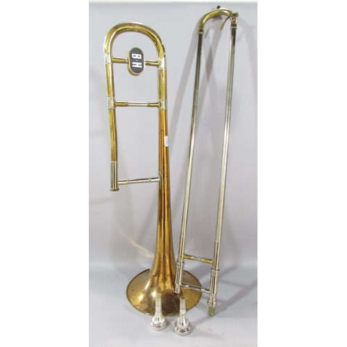 490 - A Vintage Boosey & Hawkes brass trombone, with two mouth pieces in it’s original case.