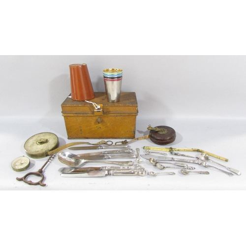 497 - A small tub of silver handled flatware, mustard spoons etc, a tin strong box, two vintage tape measu... 