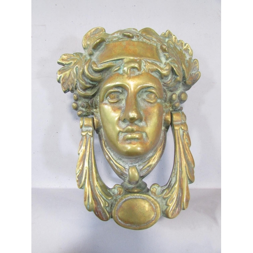 501 - A brass French Empire style Baccanalian female mask door knocker, with screw fastenings, 18cm.