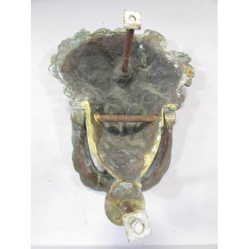 501 - A brass French Empire style Baccanalian female mask door knocker, with screw fastenings, 18cm.