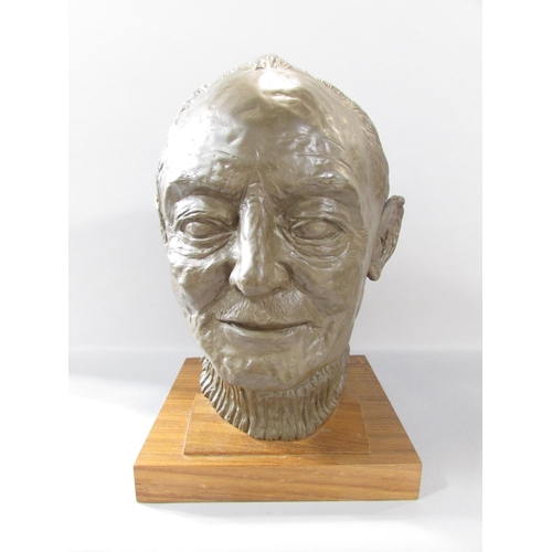 511 - A bronzed resin bust of Arthur Frith, wearing a crew neck jumper, set on a wooden plinth, 35cm high