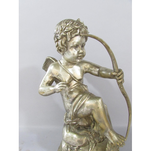 522 - A classical statuette of Cupid letting loose an arrow, his gaze fixed on his victim, in a silver met... 