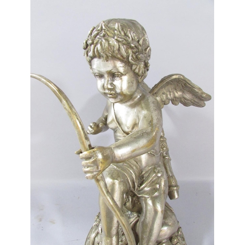 522 - A classical statuette of Cupid letting loose an arrow, his gaze fixed on his victim, in a silver met... 