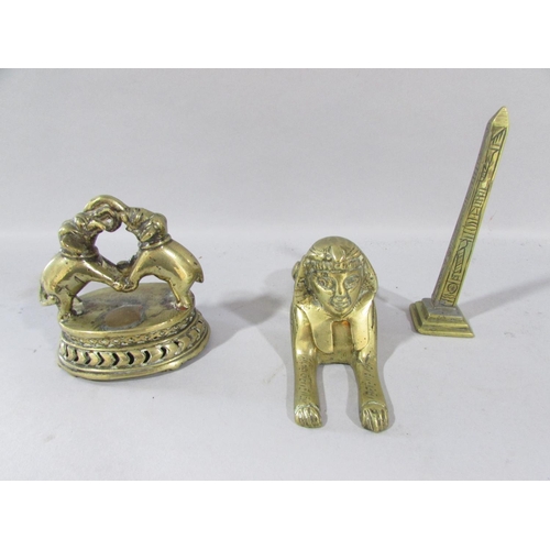 530 - A box of Indian and Egyptian style brass souvenirs, a Sphinx, fighting elephants, an Obelisk, etc an... 