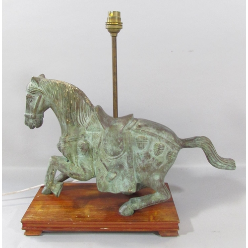 533 - A bronzed Verdigris finished Chinese horse with lamp conversion, raised on a wooden plinth. 46cm wid... 