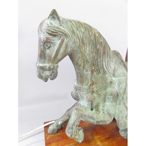 533 - A bronzed Verdigris finished Chinese horse with lamp conversion, raised on a wooden plinth. 46cm wid... 