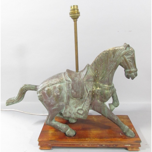 533 - A bronzed Verdigris finished Chinese horse with lamp conversion, raised on a wooden plinth. 46cm wid... 