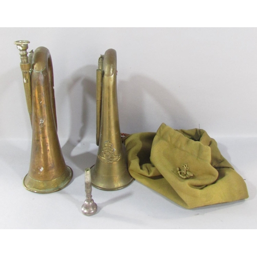 536 - Two British Military brass bugles (as found), with a cloth bag and a cap badge.