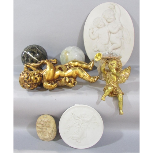 550 - A decorative gilt putti figure, a plaster putti wall plaque, a trumpet blowing winged cherub, furthe... 