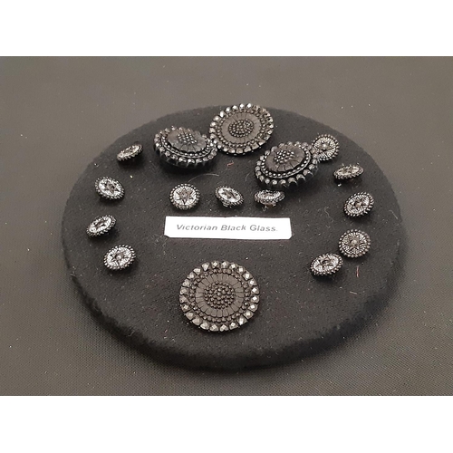 756 - A collection of individual decorative black glass buttons including finely detailed Victorian Mourni... 