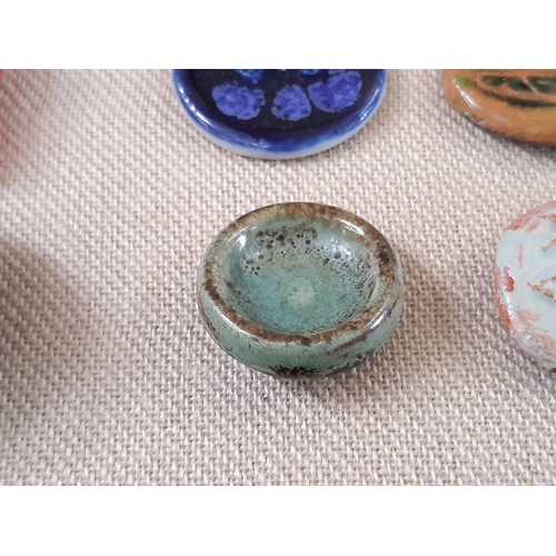 760 - A small collection of unmarked ceramic buttons including a green glazed round button 25mm possibly b... 