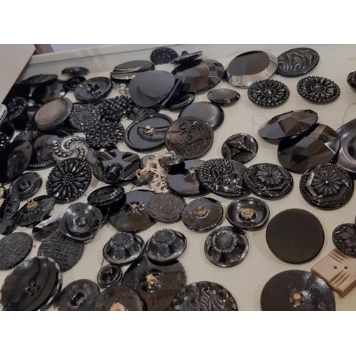 797 - A substantial collection of decorative19th - 20th century buttons housed in a 24-drawer lockable met... 