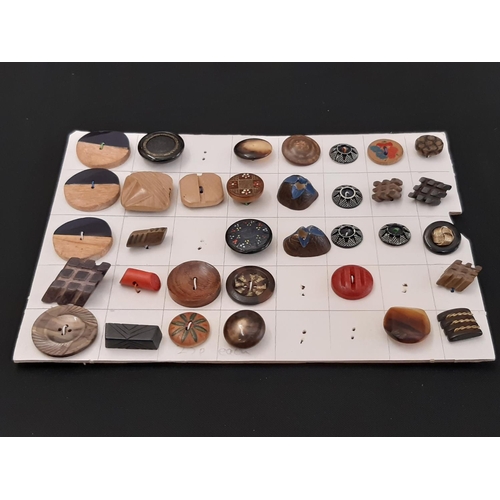 803 - A collection of 20th century decorative buttons in wood, horn, ceramic, plastic, glass etc displayed... 