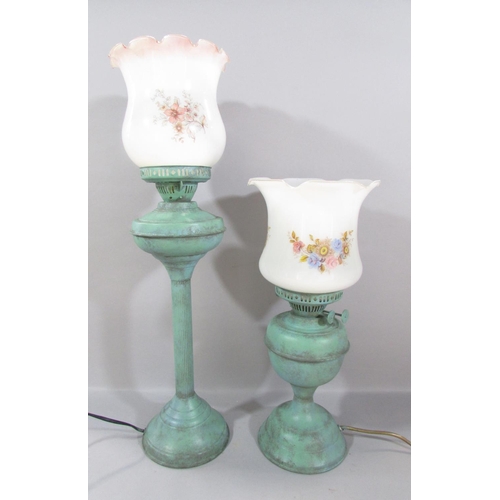 460 - Two oil lamps with a painted green wash finish converted to electric lamps, both with glass shades.