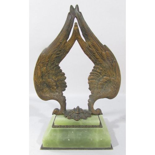 A Bronze Double Angel wing watch stand set on a green onyx base.