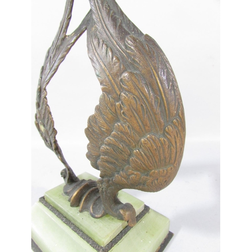 A Bronze Double Angel wing watch stand set on a green onyx base.