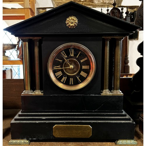 447A - A Victorian black slate mantle clock with column supports and eight-day time piece, brass presentati... 