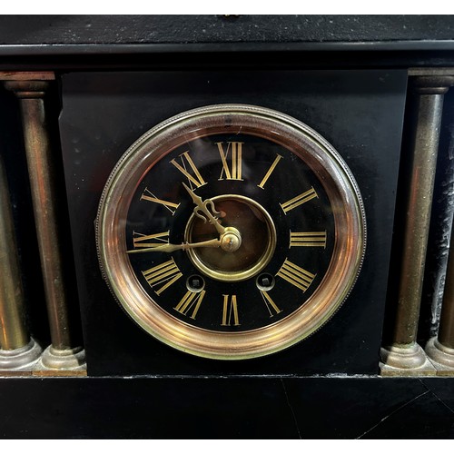 447A - A Victorian black slate mantle clock with column supports and eight-day time piece, brass presentati... 