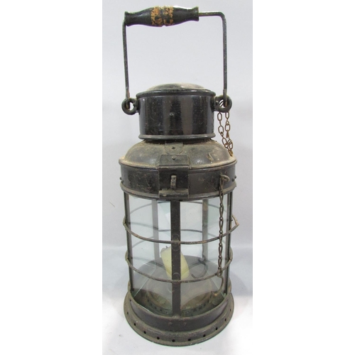 538 - A 19th century metal five glass panel storm lamp with a single candle holder, a later oil Hurricane ... 