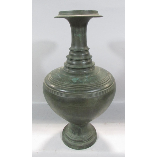 487 - An Asian heavy bronze vase, a bulbous body with a tapering ring turned neck, 49cm high.