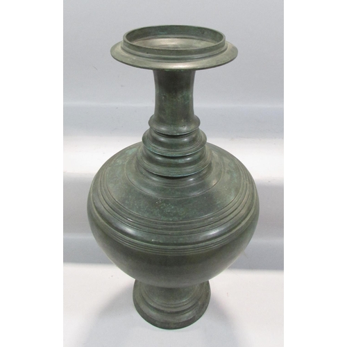 487 - An Asian heavy bronze vase, a bulbous body with a tapering ring turned neck, 49cm high.