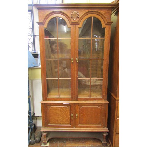 1358 - An Edwardian period oak two sectional bookcase partially enclosed by two fielded panelled doors and ... 