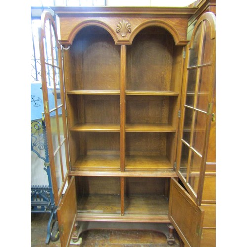 1358 - An Edwardian period oak two sectional bookcase partially enclosed by two fielded panelled doors and ... 