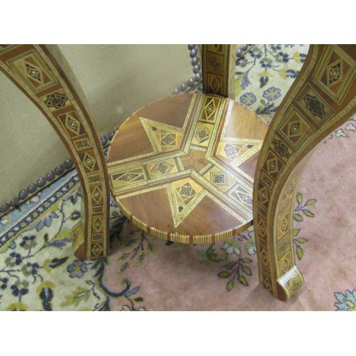 1361 - A two-tier Moroccan parquetry inlaid occasional table raised on three shaped supports, 88cm high, 48... 