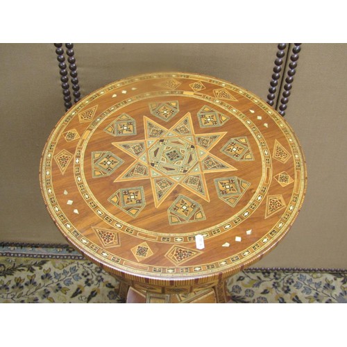 A two-tier Moroccan parquetry inlaid occasional table raised on three ...