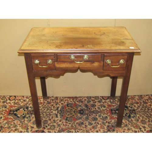 1377 - A Georgian three drawer mahogany lowboy with shaped apron, raised on moulded supports with brass swa... 