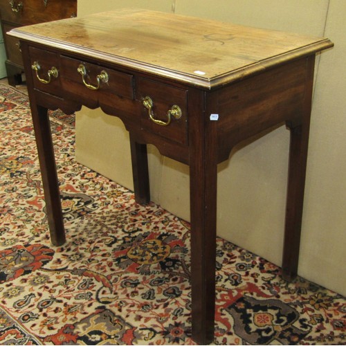 1377 - A Georgian three drawer mahogany lowboy with shaped apron, raised on moulded supports with brass swa... 