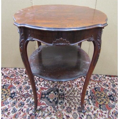 1465 - A Victorian rosewood centre table, the circular shaped outline raised on four shaped supports with u... 