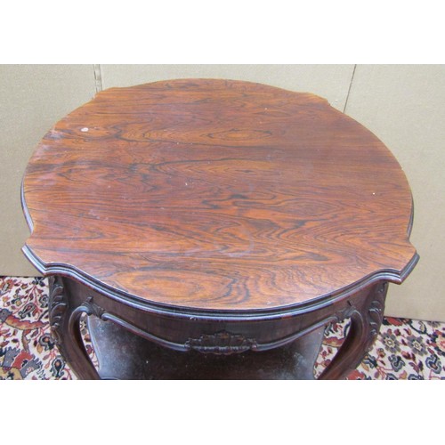 1465 - A Victorian rosewood centre table, the circular shaped outline raised on four shaped supports with u... 