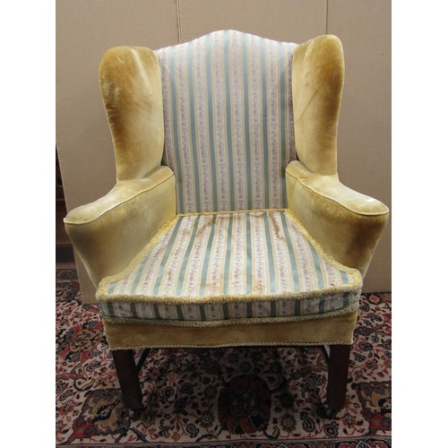 1473 - A 19th century mahogany wing chair with swept arms, raised on square cut supports with H shaped stre... 