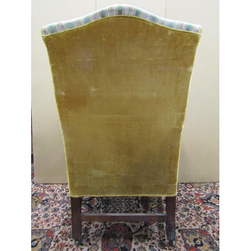 1473 - A 19th century mahogany wing chair with swept arms, raised on square cut supports with H shaped stre... 