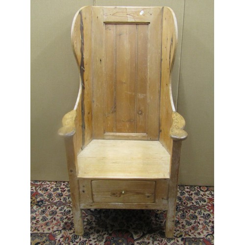 1477 - A Georgian pine lambing chair with stripped and waxed finish, the panelled back within a winged fram... 