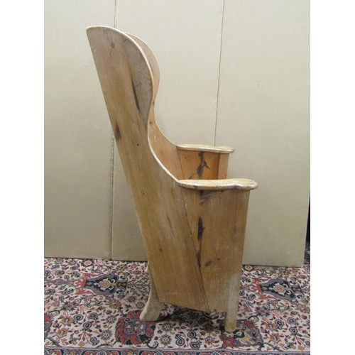 1477 - A Georgian pine lambing chair with stripped and waxed finish, the panelled back within a winged fram... 