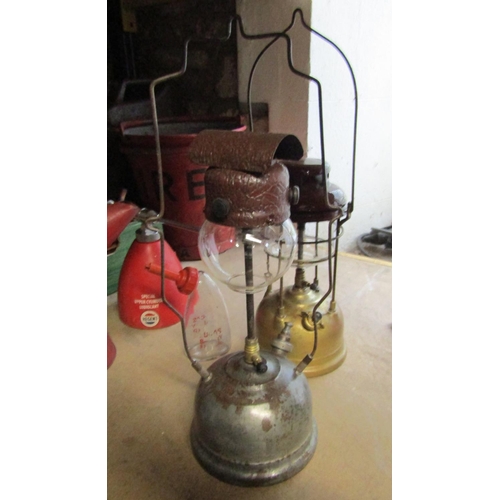 1052 - Two vintage fire buckets, box of carpenter's planes, Tilley paraffin lamps, blow lamps, garage oil c... 