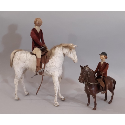 833 - Two 19th century  horse and rider leather toys comprising a white horse height 20cm with rider dress... 